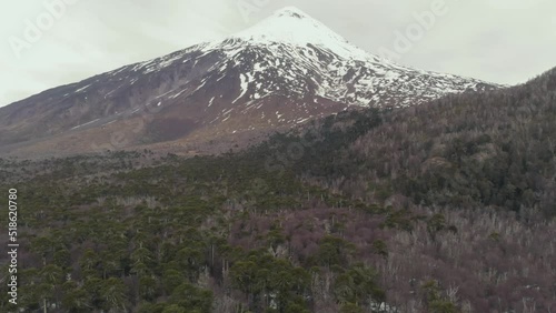 Volcan Quetrupillan covered with snow under gray clouds in Villarrica national park in Chile photo