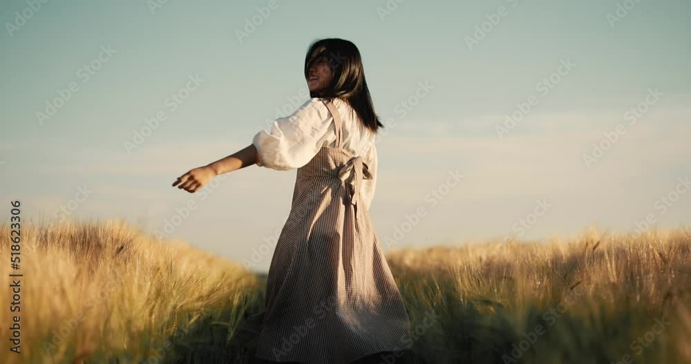 Happiness Asian woman, running on path among golden ripe wheat at the field Happiness Asian woman, running on path among golden ripe wheat at the field