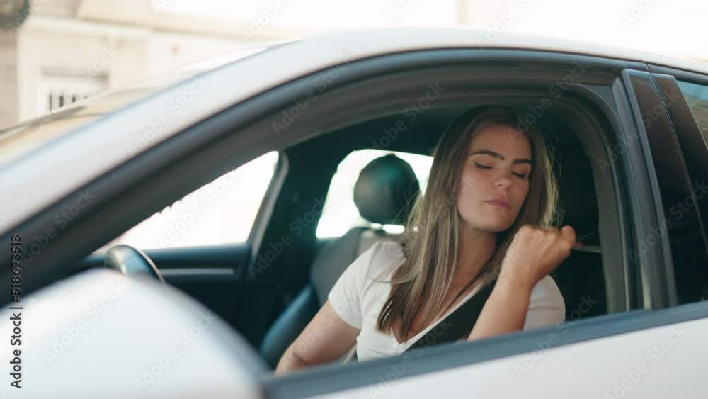 Young woman smiling confident wearing car belt at street Young woman smiling confident wearing car belt at street