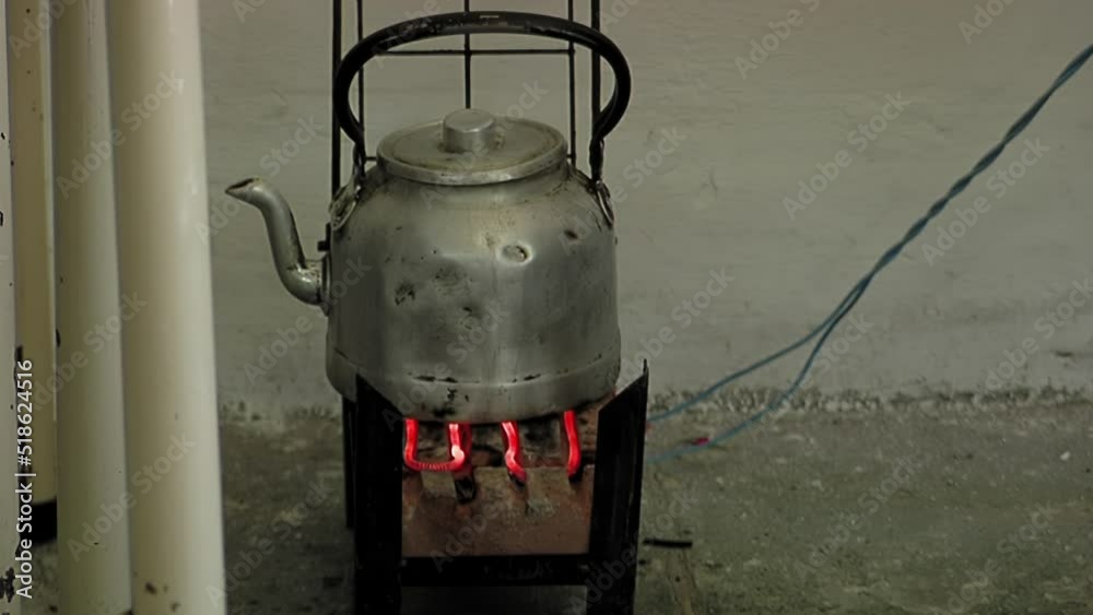Inmate Heating Water on a Small Stove Preparing a Yerba Mate Infusion