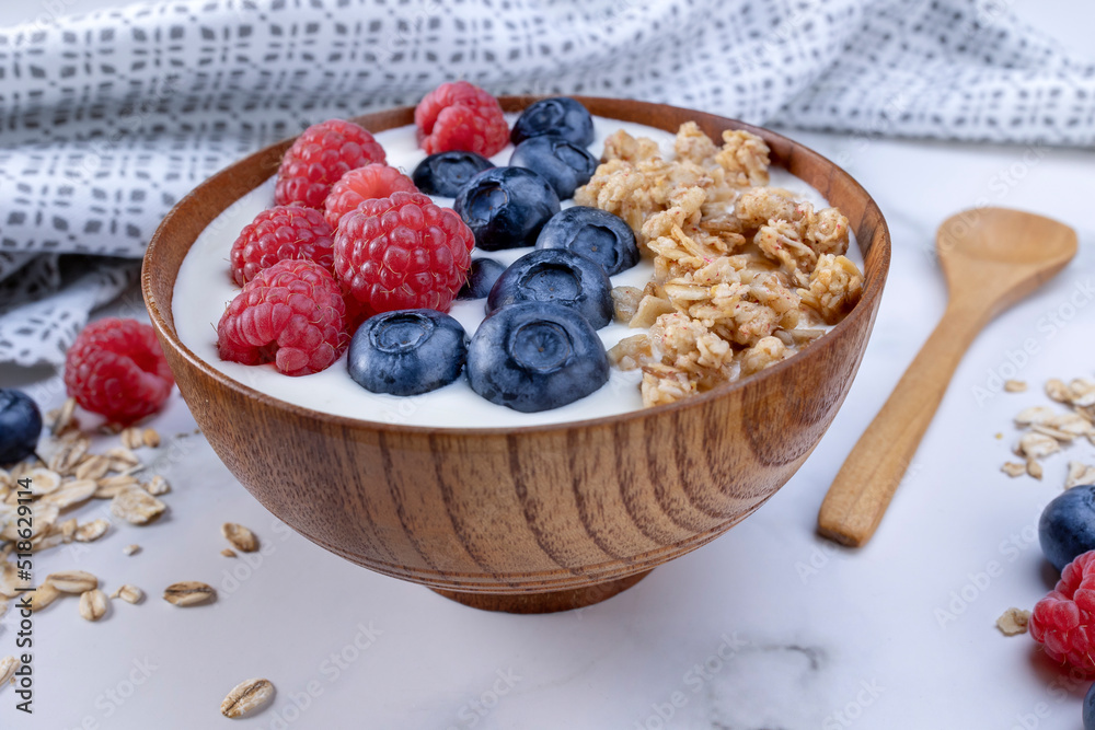 Serving yogurt with blueberry raspberry and oat flakes Serving yogurt with blueberry raspberry and oat flakes