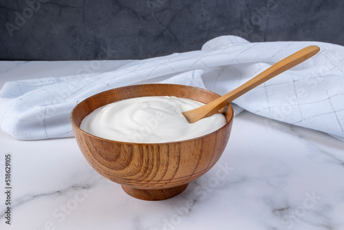 Greek yogurt in wooden bowl