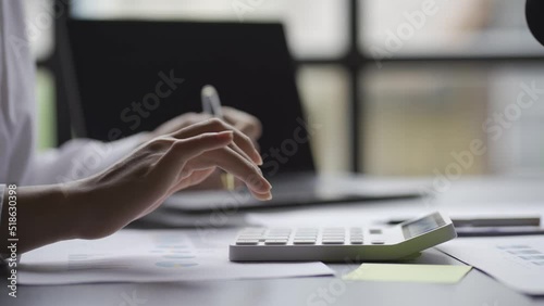 Accountants working on financial and tax reports. Calculating and managing finances Calculating income or profit read and write reports with laptop close-up business finance accounting concept