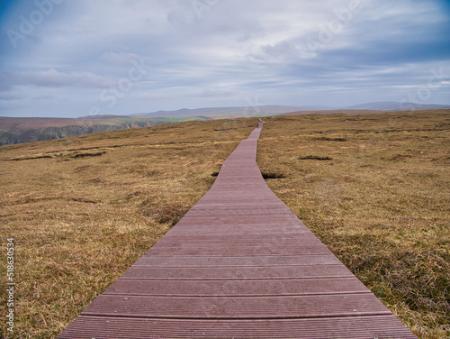 The new recycled plastic boardwalk takes visitors over fragile peatland and away from nesting birds on Hermaness Hill on the north coast of Unst, Shetland, UK. photo