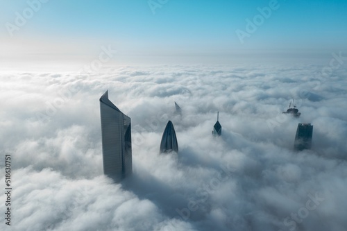 High tall building in Kuwait city covered with fog