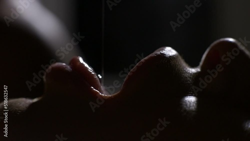 Man seduces woman in bed dripping honey in her mouth