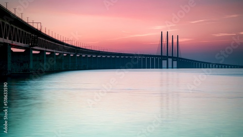 Pink sunset view from the Malmo coast -The Oresund Bridge crossing over the Oresund strait photo