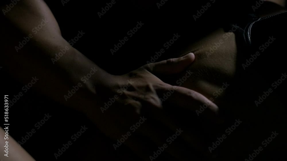Couple engaged in sexual intercourse on bed