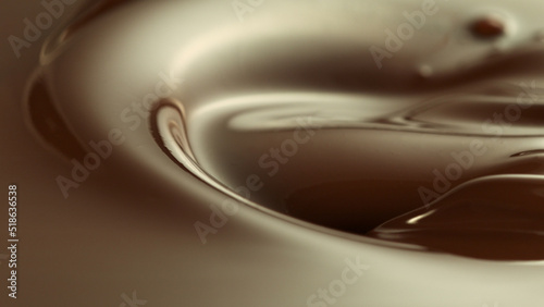 Close-up of pouring stream of melted chocolate.