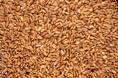 Organic uncooked brown rice, close-up, top view.