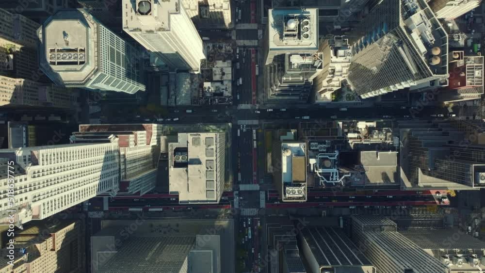 Aerial birds eye overhead top down view of streets crossing avenue. Tall residential or office buildings in midtown. Manhattan, New York City, USA