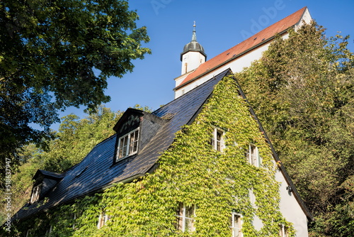 tharandt, deutschland - hausbegrünung und bergkirche photo