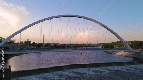 Colorful aerial drone view pushing toward Center Street Bridge in Des Moines, Iowa at sunset