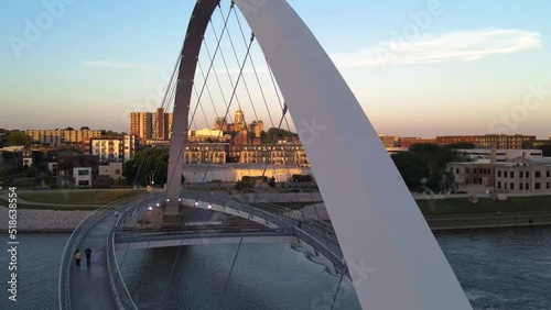 Colorful sunset aerial drone view of Center Street Bridge with gold-domed Iowa capitol building in far distance