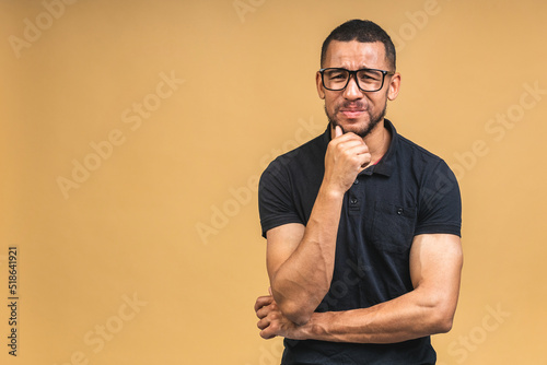 Stressed young african american man feel pain having terrible strong headache concept, tired upset black guy with migraine isolated over beige background.