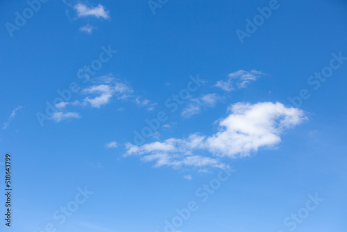 Blue sky with typical scattered white clouds in selective focus