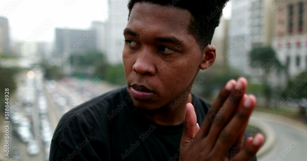 Naklejka premium Pensive young black in city thinking. Thoughtful African male