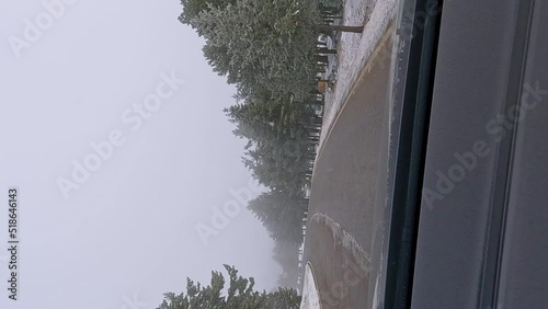 4k Vertical PoV footage from a car going through a snow mountain in a cloudy day