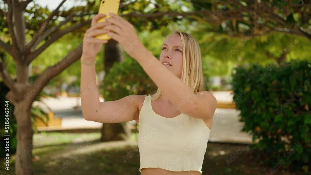 Young blonde woman smiling confident making photo by the smartphone at park Young blonde woman smiling confident making photo by the smartphone at park