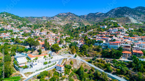 Aerial view of Agros village settlement on mountain Troodos, Limassol district, Cyprus. Bird's eye view of traditional houses with ceramic tile roof, church, countryside and rural landscape from above photo