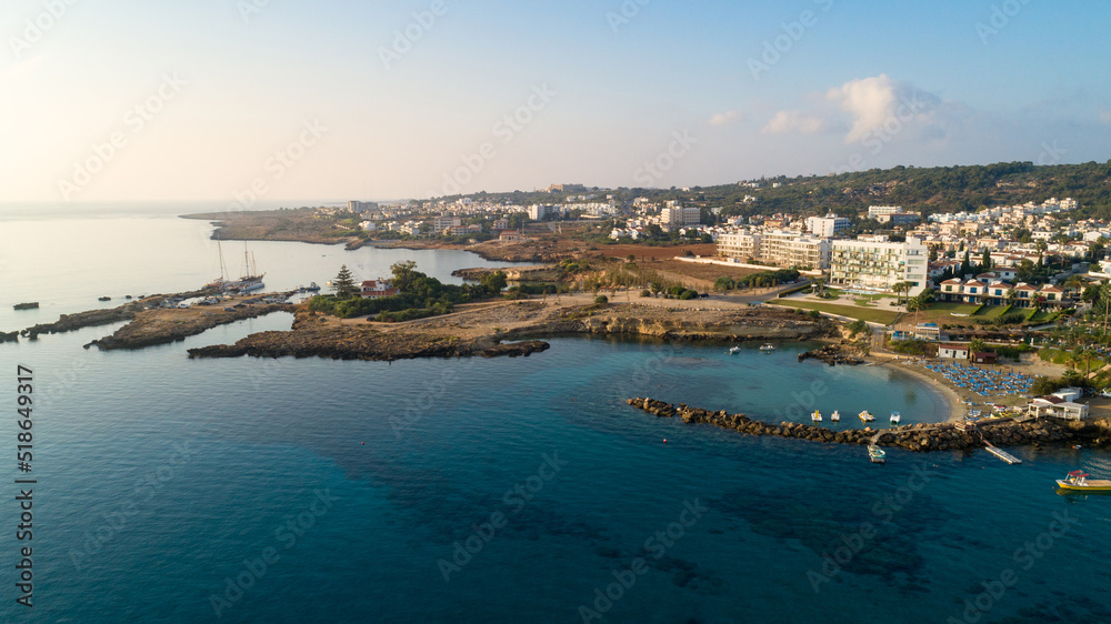 Aerial bird's eye view of Green bay Protaras, Paralimni, Famagusta, Cyprus. Famous tourist attraction diving location rock beach with boats, sea restaurant, water sports on summer holidays, from above