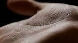 Macro shot of female model's good-looking palm on black background | Skin texture shot for hand care concept
