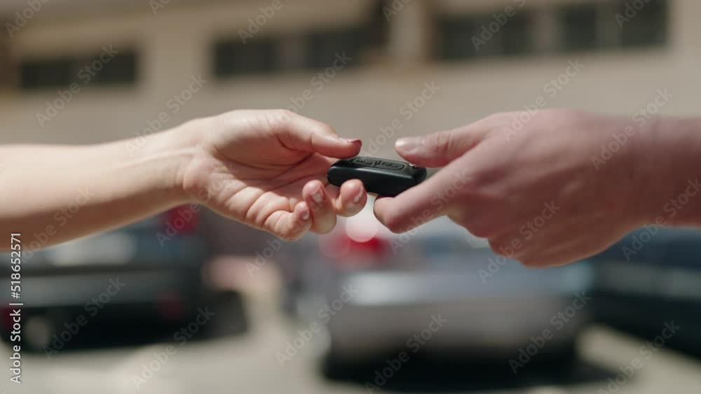 Young hispanic couple holding key of new car at street Young hispanic couple holding key of new car at street
