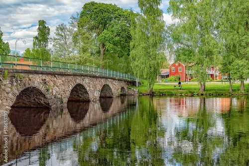 Beautiful view of the Broby stone bridge reflected on the water photo