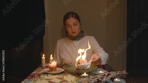 4K. Slavic woman set fire to paper