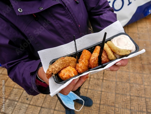 Closeup of fried street food in a plastic container in Ostend, Belgium photo