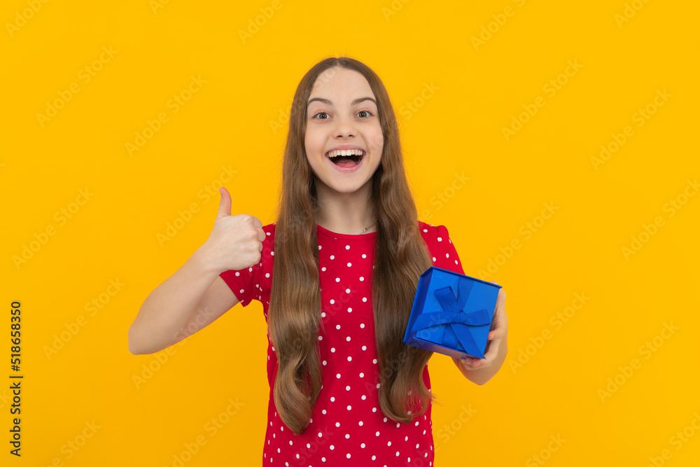 Teenager kid with present box. Teen child girl giving birthday gift. Present, greeting and gifting concept. Teenager kid with present box. Teen child girl giving birthday gift. Present, greeting and gifting concept.