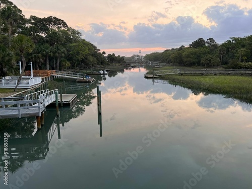 Colorful sunset sky reflected in Fripp Island Channel with docks and constructions photo