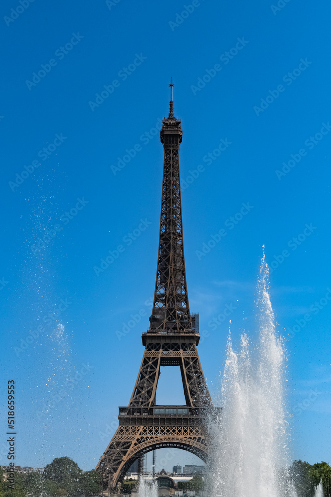 Paris, the Eiffel Tower, beautiful monument in summer, with water jets at Trocadero 
