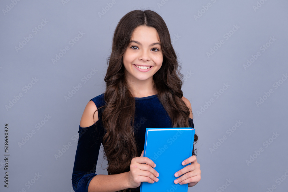 Teenager schoolgirl hold book and copybook ready to learn. School children on isolated grey background. Happy face, positive and smiling emotions of teenager schoolgirl. Teenager schoolgirl hold book and copybook ready to learn. School children on isolated grey background. Happy face, positive and smiling emotions of teenager schoolgirl.