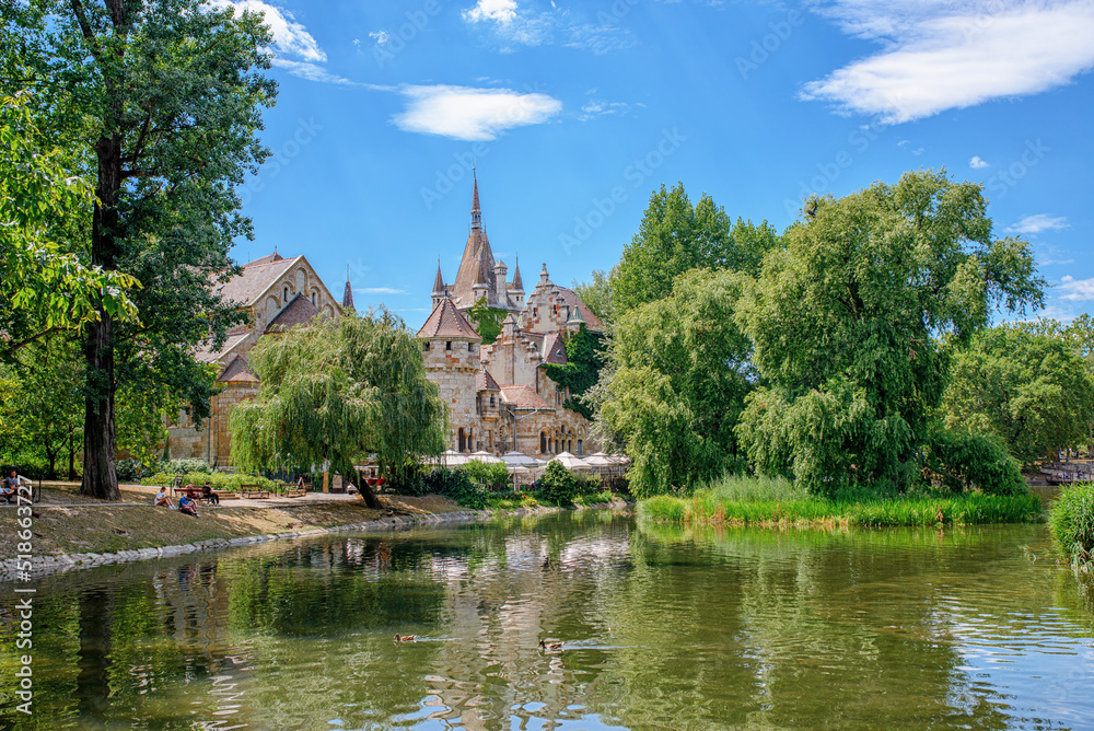 Historical building in Budapest - Vajdahunyad Castle with lake over the blue sky in main City Park. Historical building in Budapest - Vajdahunyad Castle with lake over the blue sky in main City Park.