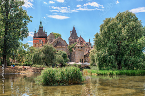 Historical building in Budapest - Vajdahunyad Castle with lake over the blue sky in main City Park.