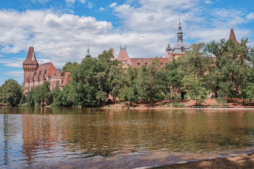 Historical building in Budapest - Vajdahunyad Castle with lake over the blue sky in main City Park.