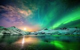 Wonderful scenery of northern lights (Aurora borealis) over snowy mountains and a lake