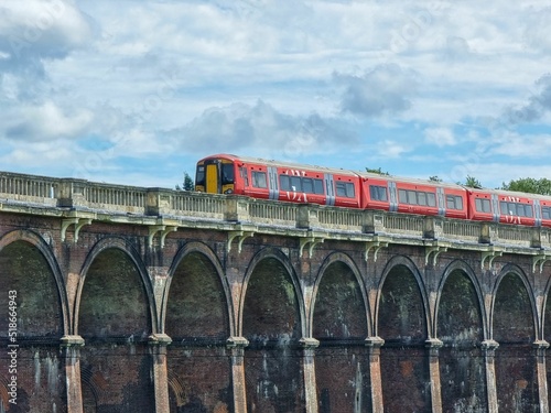 A Gatwick Express train crosses over the Balcombe Ouse Valley Viaduct, Sussex, England photo