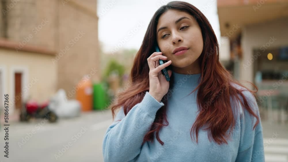Young hispanic woman smiling confident talking on the smartphone at street Young hispanic woman smiling confident talking on the smartphone at street