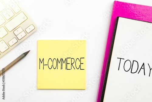 Vector of hand writing sign 'M-Commerce' on notebook with 'today' sign in white background photo