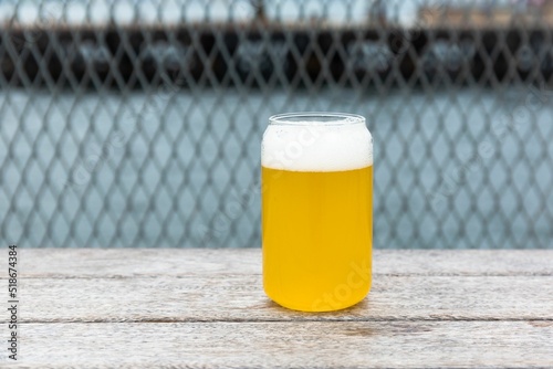 Fototapet Light lager beer in a glass on a pier