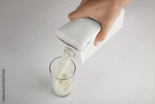Hand with a container of milk (ID: 518675352)