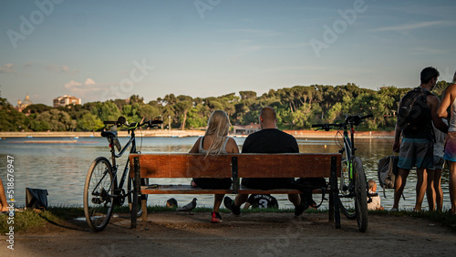 Couple is  sitting on the bench, chilling in the park of Madrid © Nikita