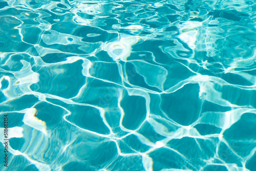 turquoise color background of swimming pool water with ripples in summer