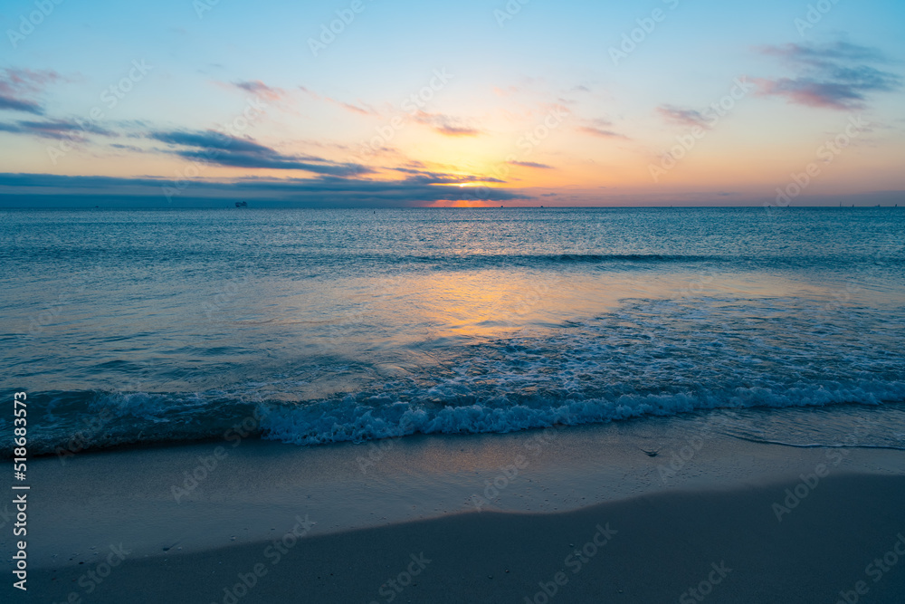 beautiful dawn with sea water on the summer beach