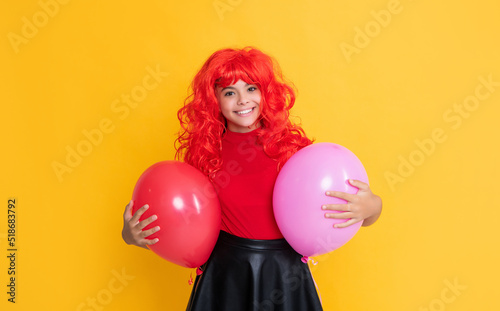 cheerful teen child with party balloon on yellow background © be free