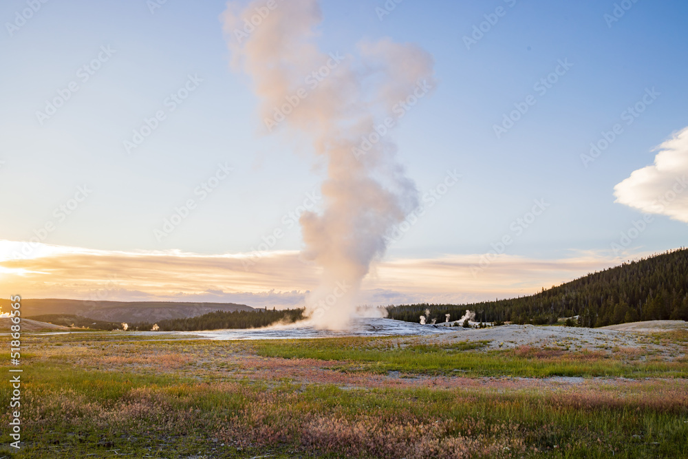 Sunset view of the Old Faithful geyser