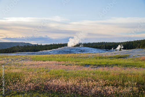 Sunset view of the Old Faithful geyser