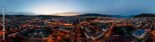 Night panorama of the city of Magadan. A wide panoramic aerial view of a large northern city located in the Russian Far East. Top view of the streets and buildings. Magadan region, Siberia, Russia.